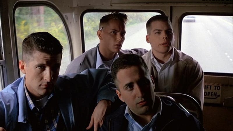 In this image from Dogfight, four young clean-cut Marines nicknamed the B-Boys are depicted in a bus.