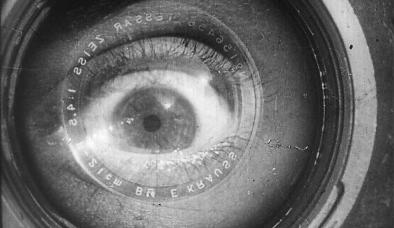 An image from Man with a Movie Camera depicts a close-up of a human eye superimposed with a camera lens.