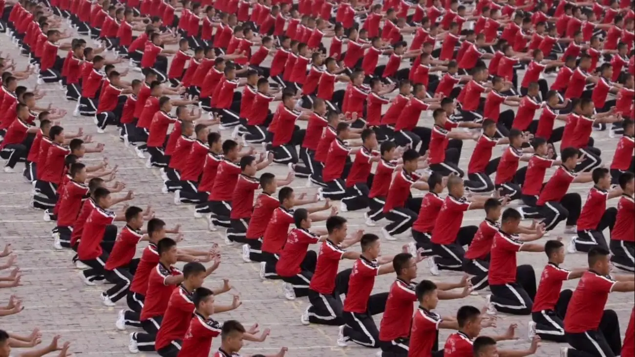Still from Practice, one of the newly added Criterion Channel Short Films. Rows of Shaolin martial artists practice a move