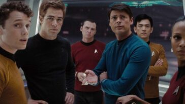 The crew of the starship Enterprise converse on the bridge.