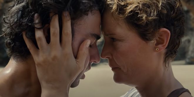 Prisca (Vicky Krieps) comforts her terrified son, Trent (Alex Wolff), after he mysterious aged almost a decade in a matter of hours on a mysterious beach.