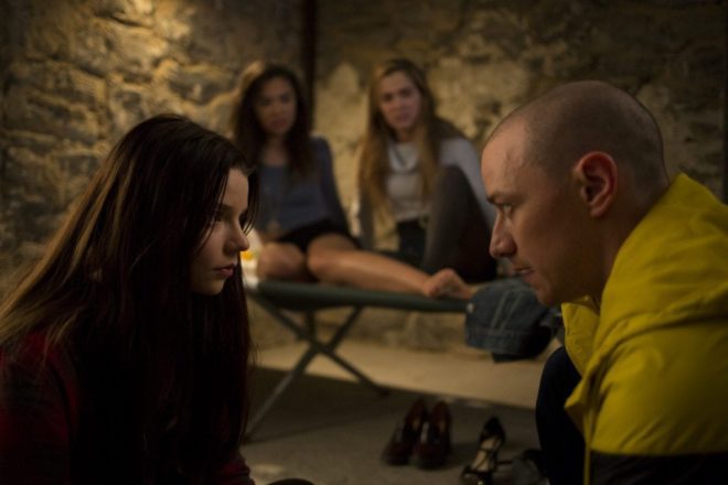 Casey (Anya Taylor-Joy) tries to trick Hedwig (James McAvoy, one of Kevin Wendell Crumb's personalities, into letting them free of as Claire (Hayley Lu Richardson) and Marcia (Jessica Sula) watch on from their bed.