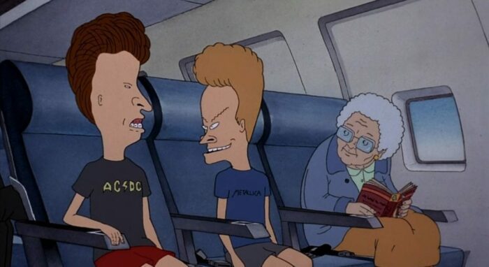 Beavis and Butt-Head sit on an airplane next to an old woman wearing glasses
