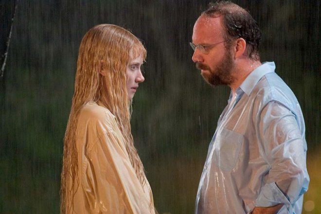 Cleveland Heep (Paul Giammati) stands in the rain with a magical Narf named Story (Bryce Dallas Howard) in an attempt to get her back to her home.