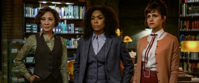 The Librarians (Michelle Yeoh, Angela Bassett and Carla Gugino) stand in their Library.