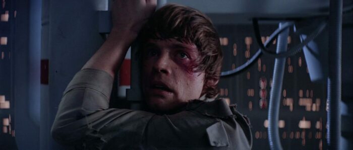 A horrified Luke Skywalker (Mark Hamill) clings on to a metal pole in the Death Star (Star Wars)
