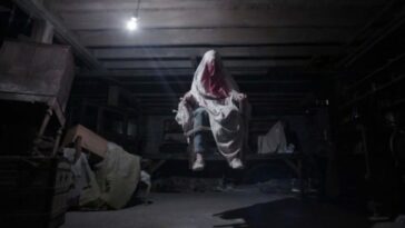 Possessed by a demon in her home, Carolyn Perron (Lili Taylor) begins floating in air during an exorcism.