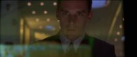 In this image from Gattaca, the character Vincent Freeman (Ethan Hawke) is depicted gazing at a computer terminal screen.