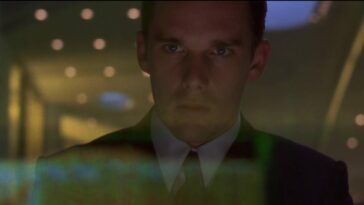 In this image from Gattaca, the character Vincent Freeman (Ethan Hawke) is depicted gazing at a computer terminal screen.