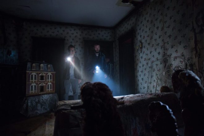 Ghost hunters Specs (Leigh Whannell) and Tucker (Angus Sampson) investigate a room of a house that is potentially haunted my an evil spirit.