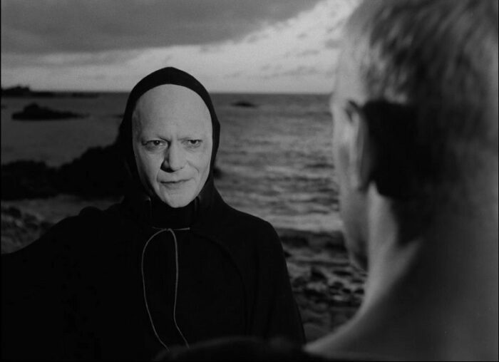 In this image from The Seventh Seal, Death (played by Bengt Ekerot) confronts Antonius Block (Max von Sydow) on a rocky shore.