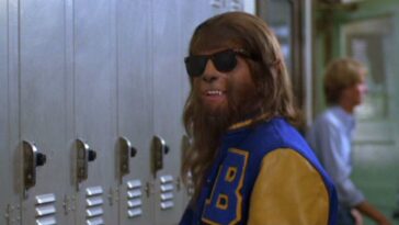 Scott, as the wolf, in a letterman jacket and sunglasses