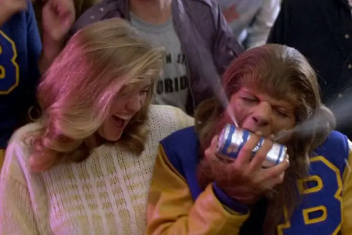 Scott, as the wolf, with Pamela by his side, bites into a can of beer.