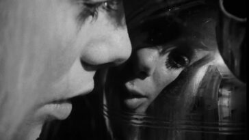 In this image from Repulsion, Carol (Catherine Deneuve) is depicted in close-up inspecting a distorted image of herself in an urn.