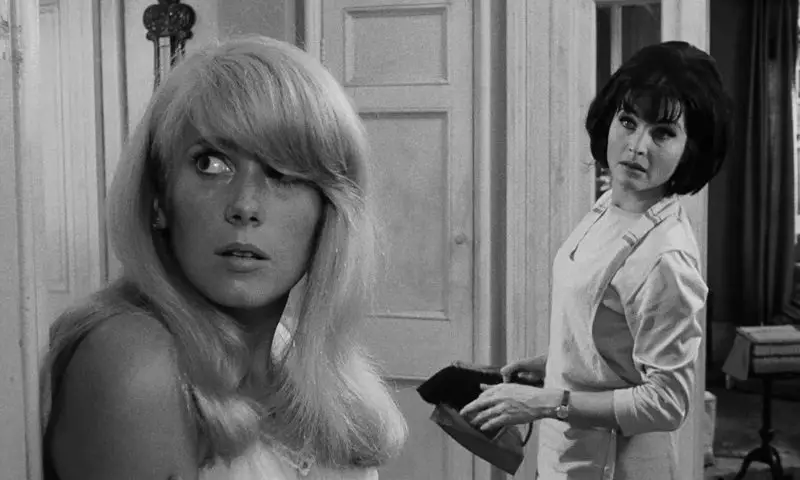 In this image from Repulsion, the characters Carol (Catherine Deneuve) and Helen are depicted in their apartment staring at a small crack in the wall plaster.