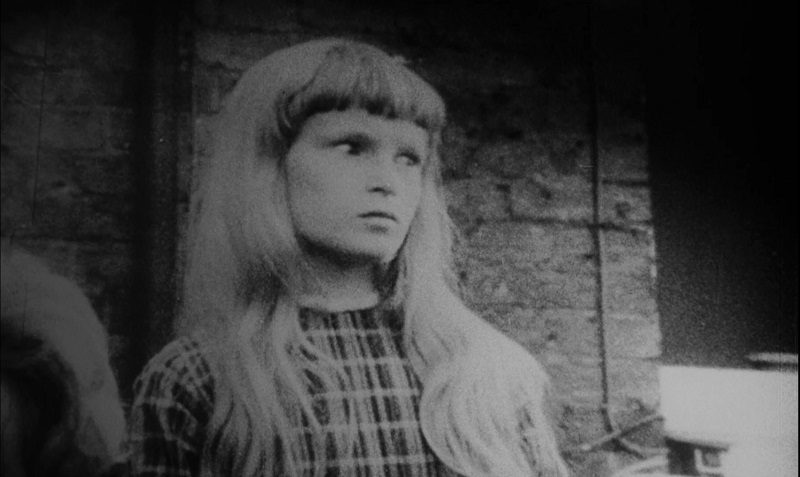 In this image from Repulsion, a younger Carol is depicted in an old family photo staring intently to the right.