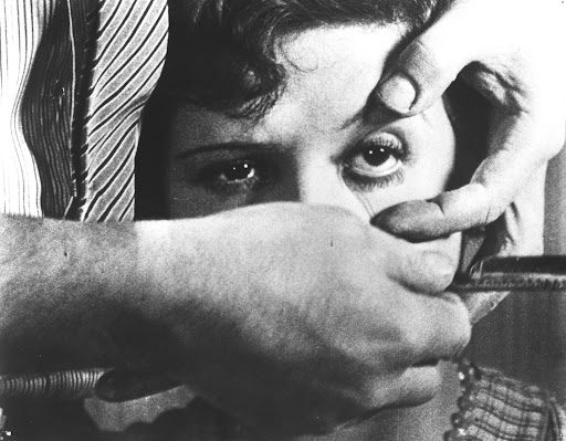 In this image from Un Chien Andalou, a man holds a straightrazor to a woman's eye.