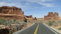 A road wanders through the buttes and mesas of the American southwest.