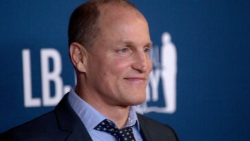 Woody Harrelson appears on a red carpet for photographs