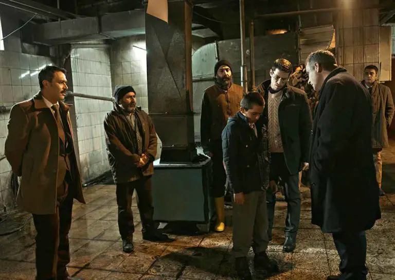 Teachers surround Yusuf in the boiler room, hearing his confession