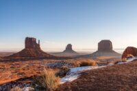 A clear daytime view of Monument Valley occupying Arizona and Utah