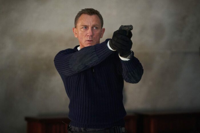 James Bond points his pistol at an adversary.