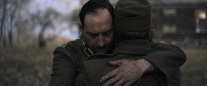 Two soldiers embrace in a moment of reunion