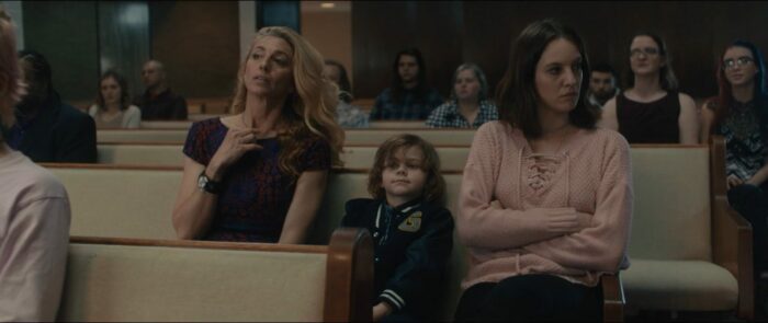 Joan (Claudia Black), Jenny (Eleanore Lambert) and Little Andrew attend church.