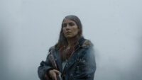 Noomi Rapace standing with a shotgun in Lamb
