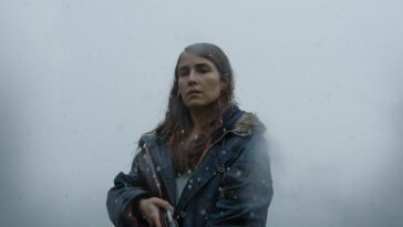 Noomi Rapace standing with a shotgun in Lamb