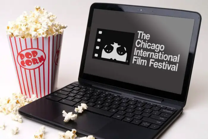 A Chicago Film Festival laptop sits next to a box of popcorn.