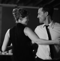 A married couple looks at each other while dancing