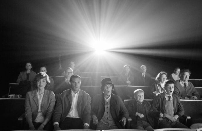 A row of family sits awestruck in a theater.