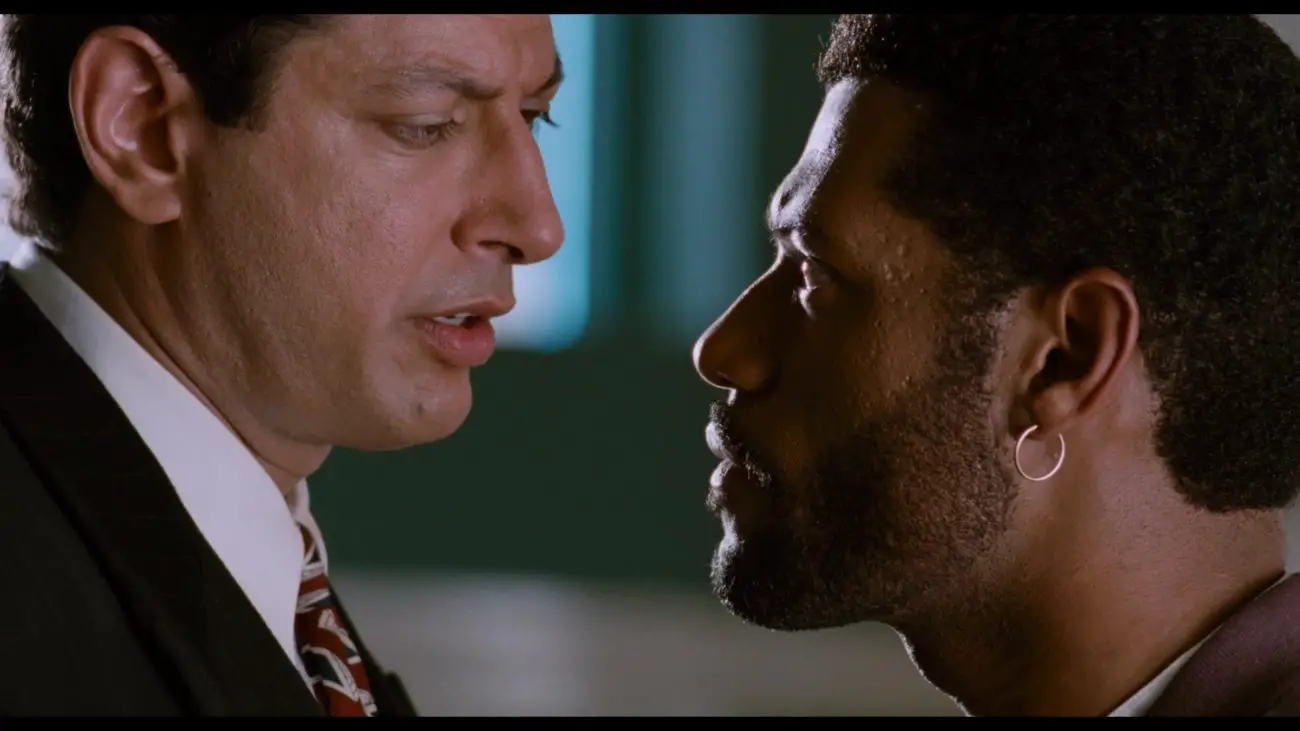 Image from Deep Cover: David Jason (Jeff Gloldblum) and Stevens/Hull (Fishburne) face each other in close-up/profile.