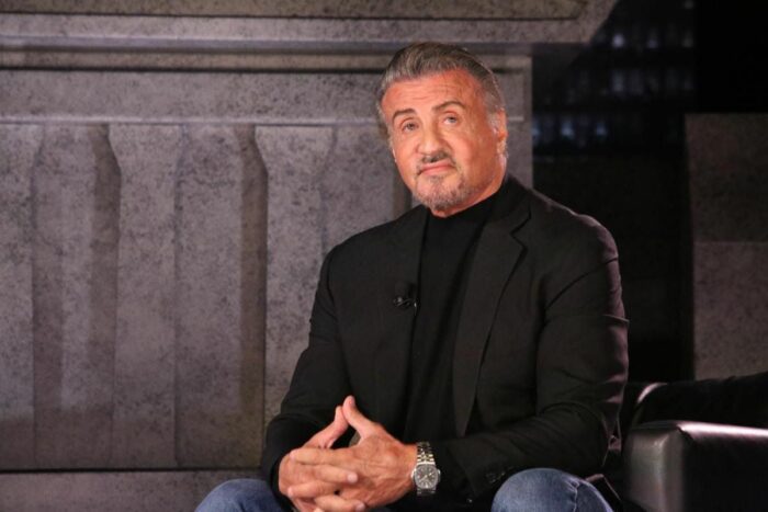 Sylvester Stallone looks on at the assembled crowd from his seat.