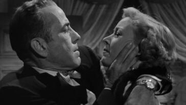 Dix Steele (Humphrey Bogart) grabs Laurel (Gloria Grahame) by the face in the film In a Lonely Place