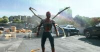 Spider-Man standing on a bridge with debris behind him