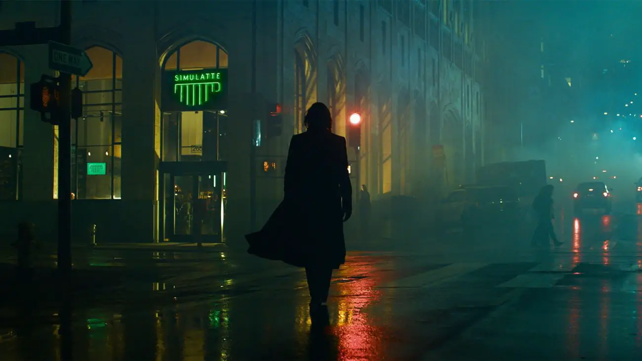 Neo (Keanu Reeves) walks purposefully through the rainy city night