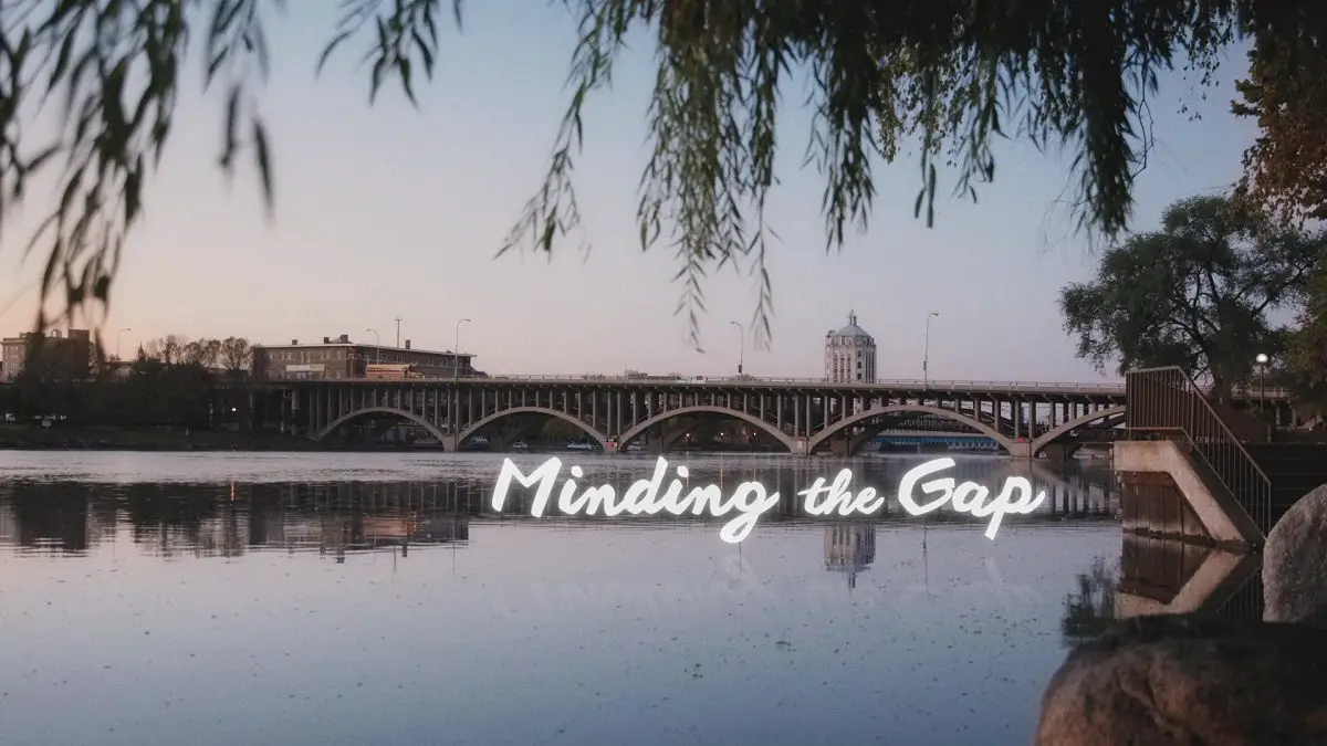 Image from Minding the Gap: A bridge over the Rock River in Rockford, IL with the words "Minding the Gap" in script at lower left.