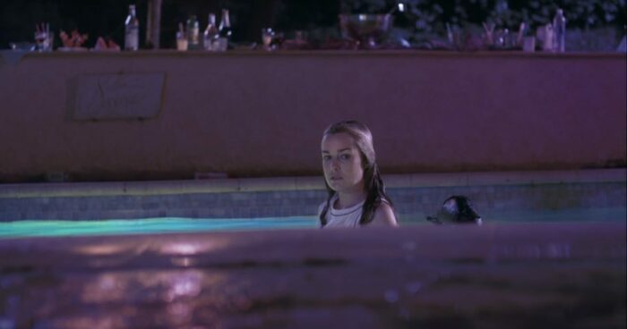 Still from Social Butterfly, one of the December Criterion Channel Short Film recommendations. Margaret looks at the camera while standing in a pool.