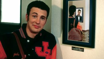 Chris Evans' character from Not Another Teen Movie, standing in front of a portrait of himself looking at a portrait of himself