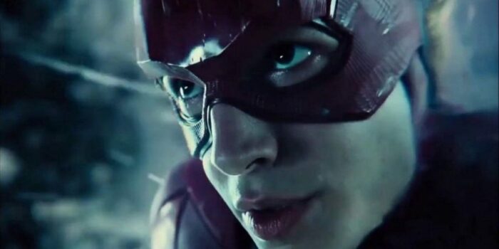A close up of The Flash (Ezra Miller)'s face while using his super speed in the 2021 Snyder Cut of Justice League. The background is unclear, a mix of black and dull blue.