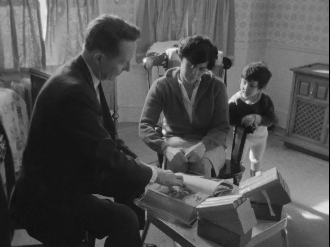 Image from Salesman: Paul Brennan (left) demonstrates an illustrated bible to a prospective customer and her daughter.
