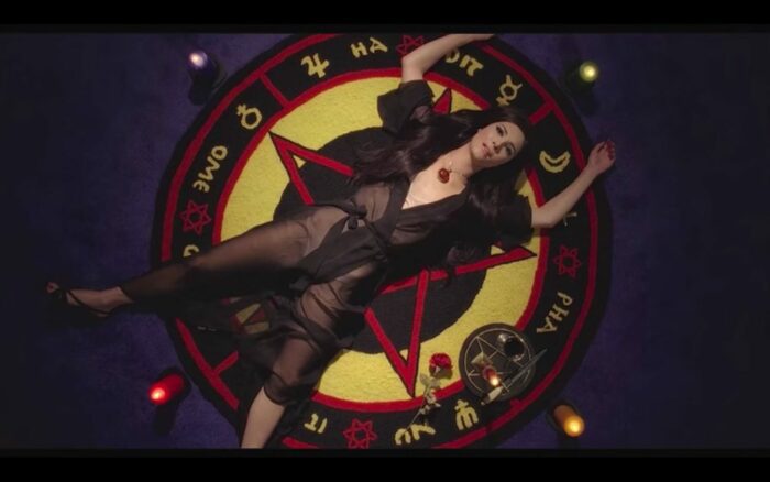 Elaine casting a love witch spell on Biller's custom-made Persian wool rug.