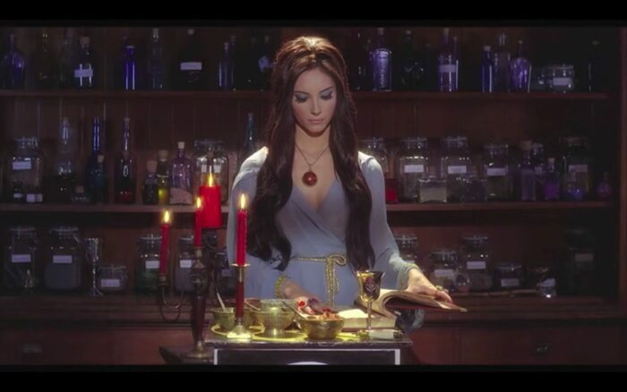 Elaine, the love witch, mixes a potion in her apartment.