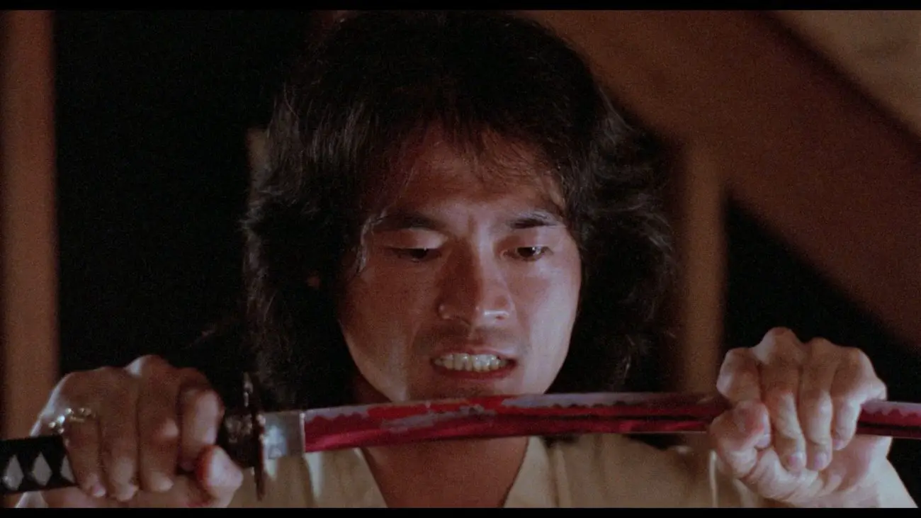 Liu holding a bloody sword