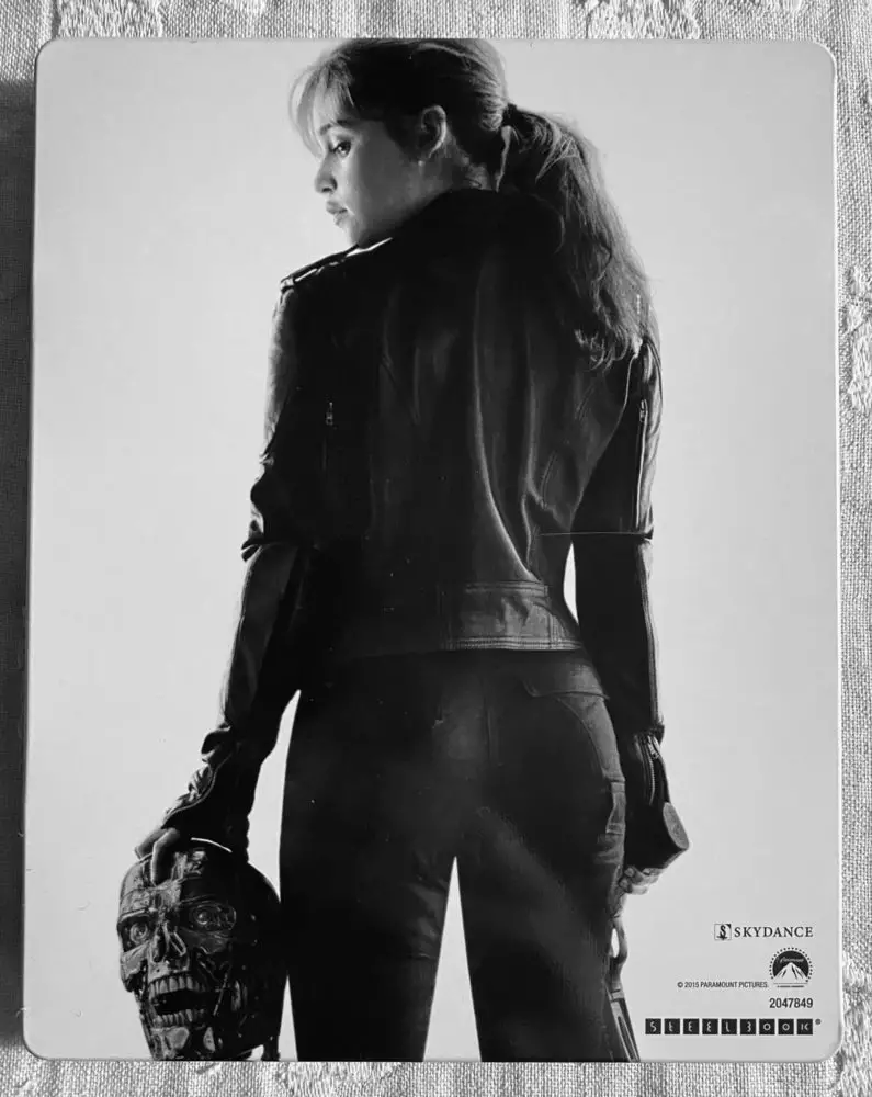 Emilia Clarke with her back facing on the cover of the steelbook for Terminator Genisys