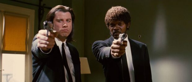 Vincent (John Travolta) and Jules (Samuel L. Jackson) get ready to open fire in the apartment of someone who owes them money in PULP FICTION.