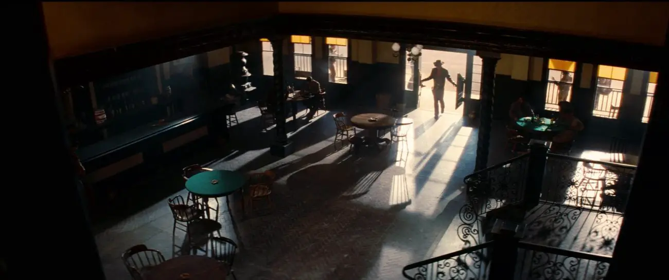 Image from Once Upon a Time... in Hollywood: Johnny Madrid, in silhouette, walks into a nearly-empty saloon