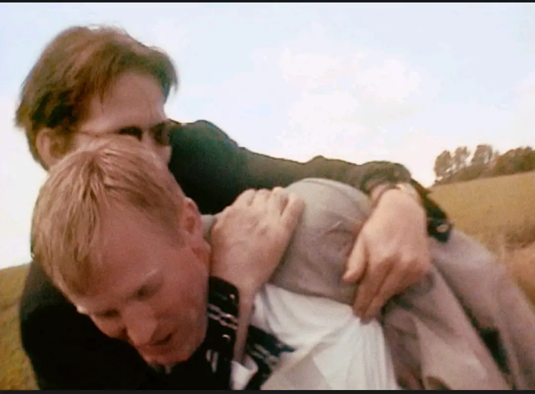 Image from The Celebration: A medium shot of Christian (Ulrich Thomsen) being embraced by Michael (Thomas Bo Larsen)